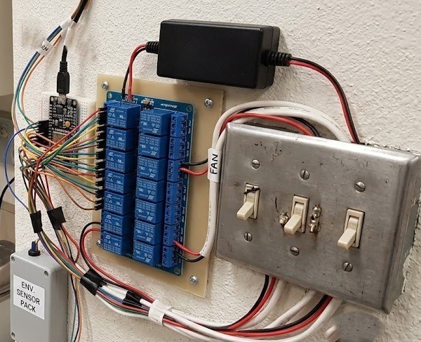 The relay module actively wired to lab appliances and environmental testing equipment, demonstrating practical application and wire routing.